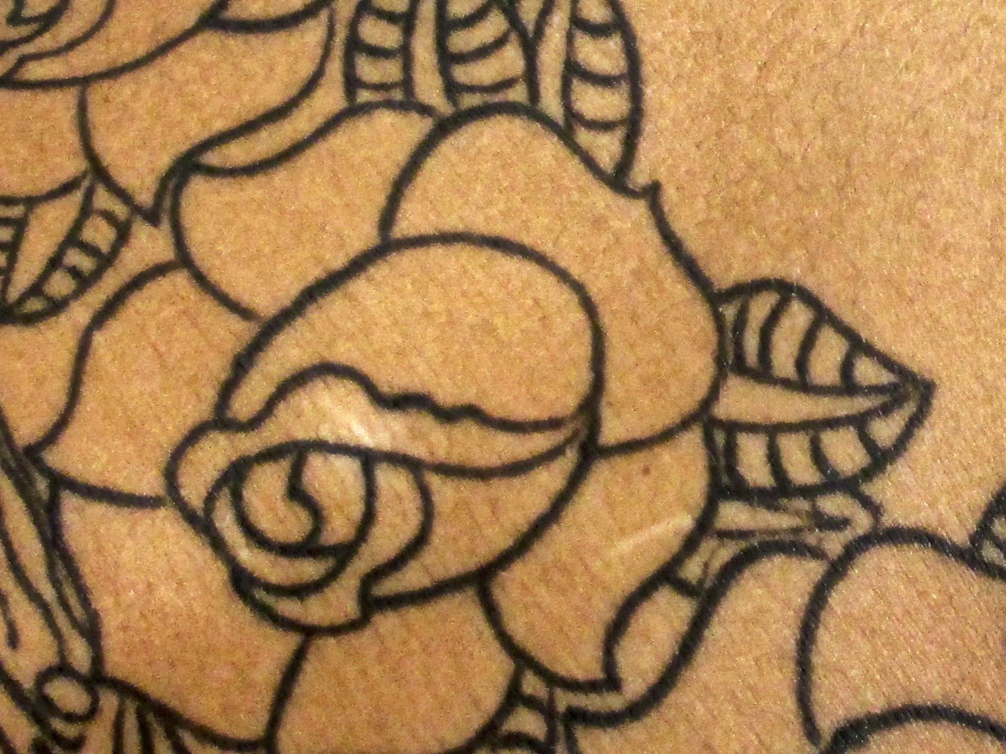 outline flower tattoo before removal